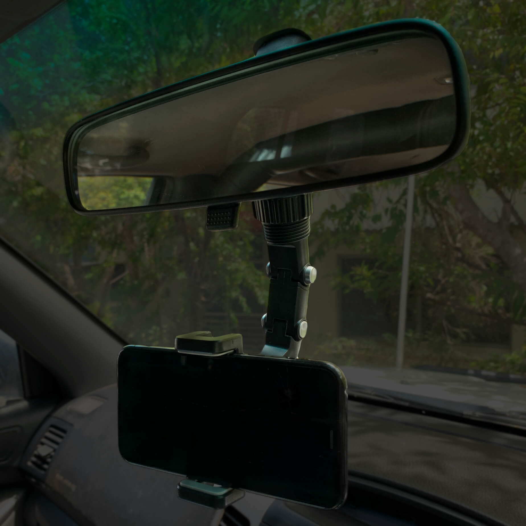 Rear view mirror phone holder being used in a car with landscape orientation